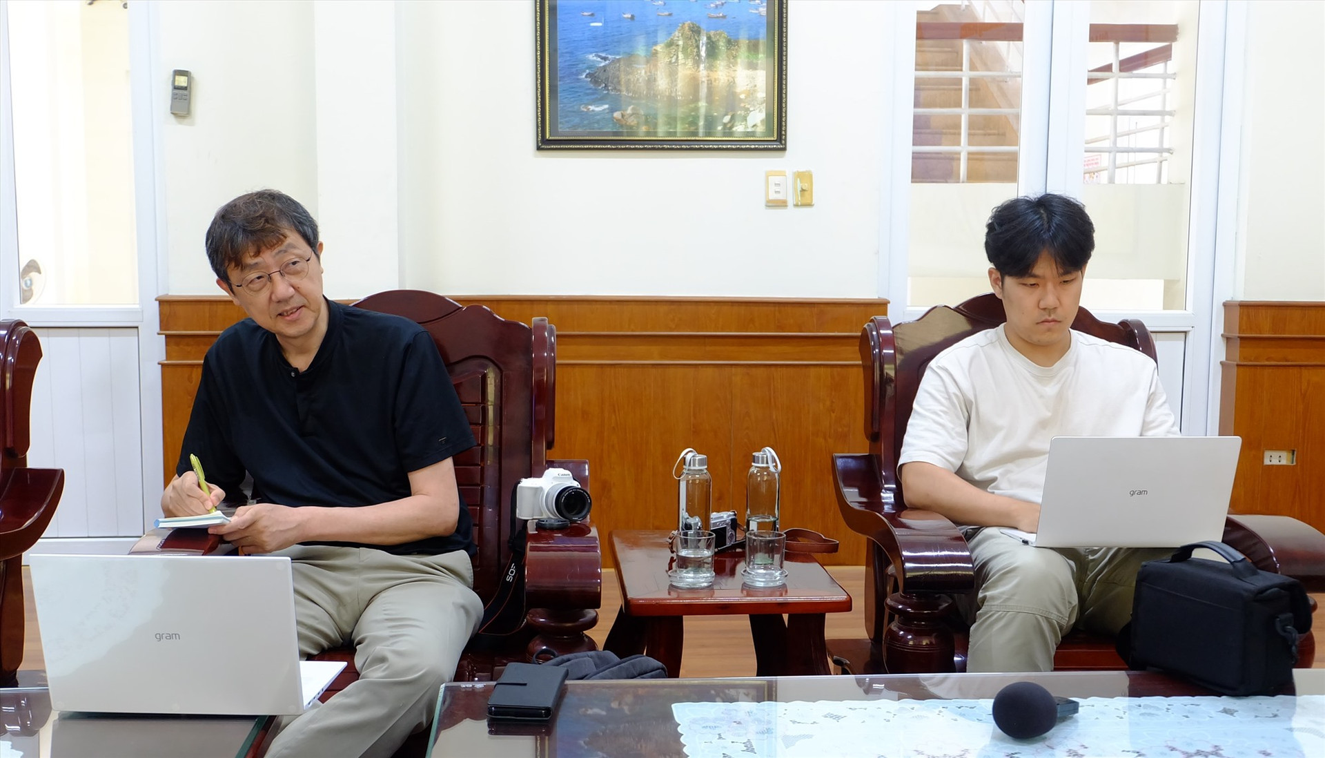 Nhà báo Koh Kyoung Tae (bên trái) tìm hiểu thông tin về tấm văn bia tại Khu tưởng niệm vụ thảm sát Hà My. Ảnh: M.L