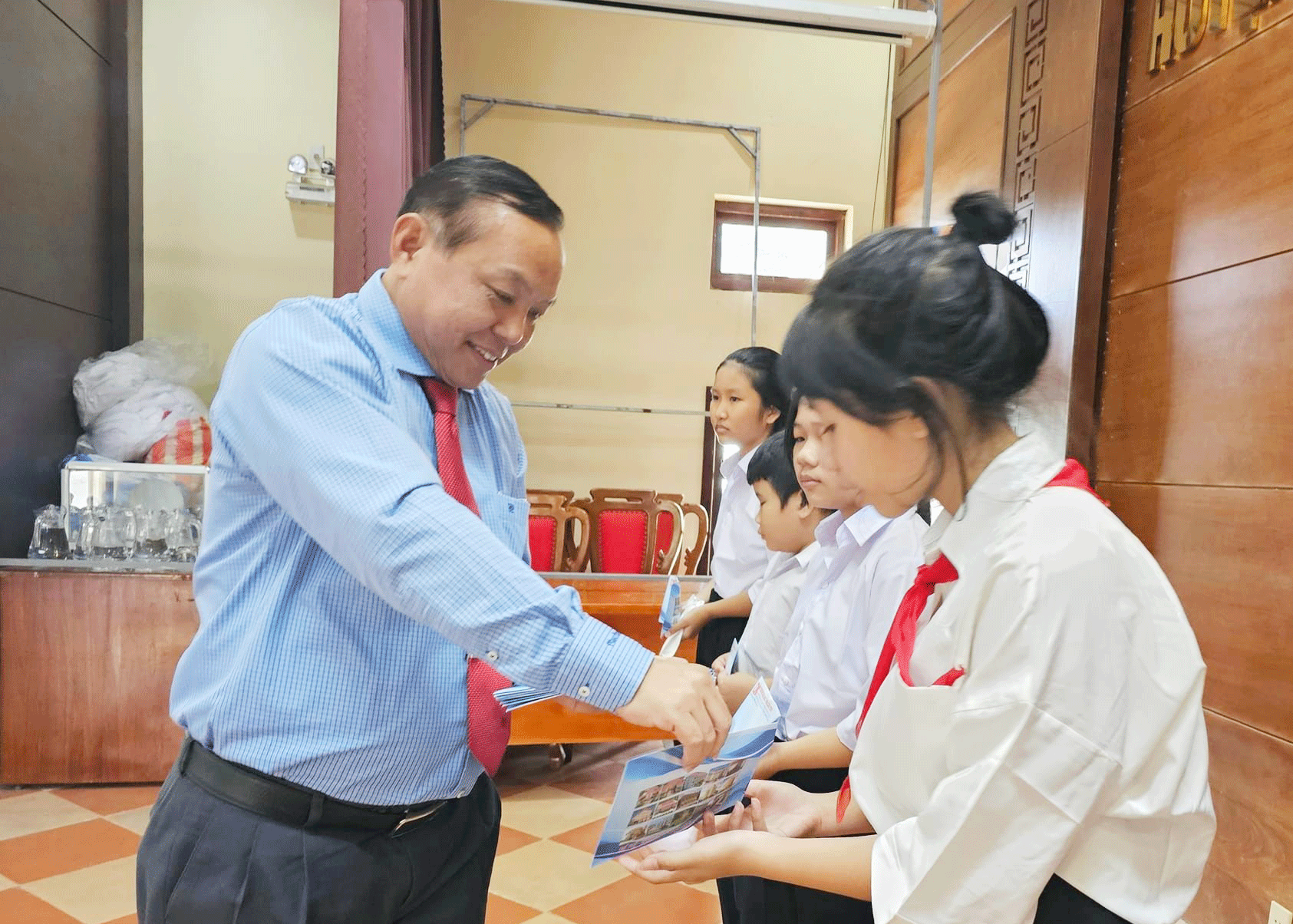 Tiến sĩ - Luật sư Nguyễn Tiến Dũng trao học bổng cho học sinh quê nhà. Ảnh: PHAN VINH
