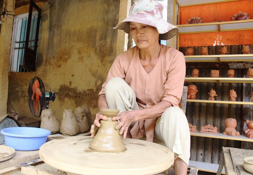 A clay pot lid is being shaped by artisan Nguyen Thi Thuy. Photo: daidoanket.vn