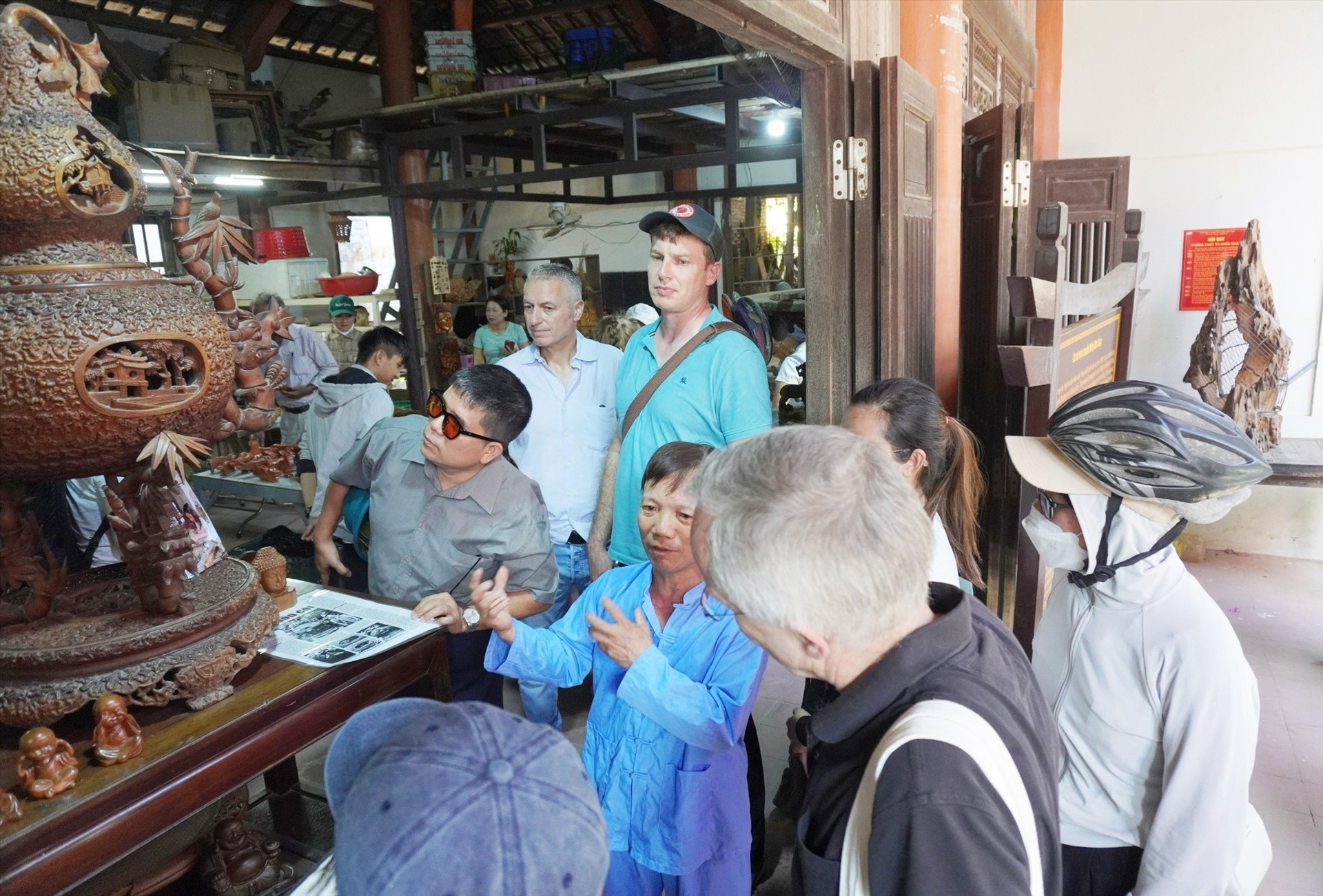 Visitors listening to a story about a traditional craft village in Cam Kim