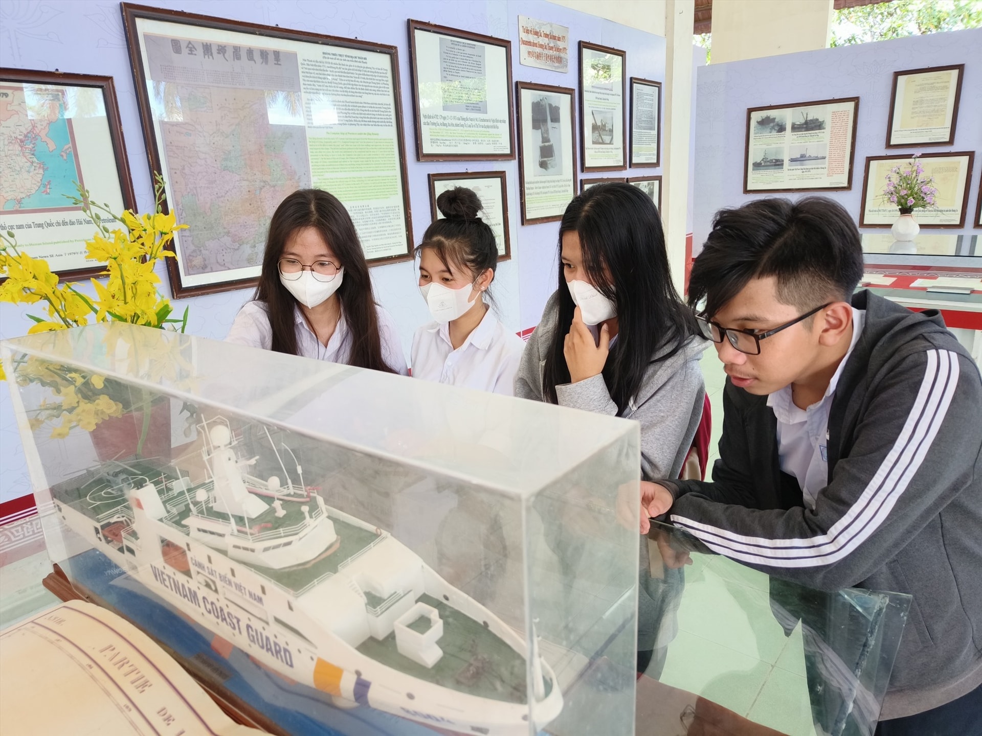 Students enjoy looking at the model of Vietnam Coast Guard Ship displayed at the exhibition.