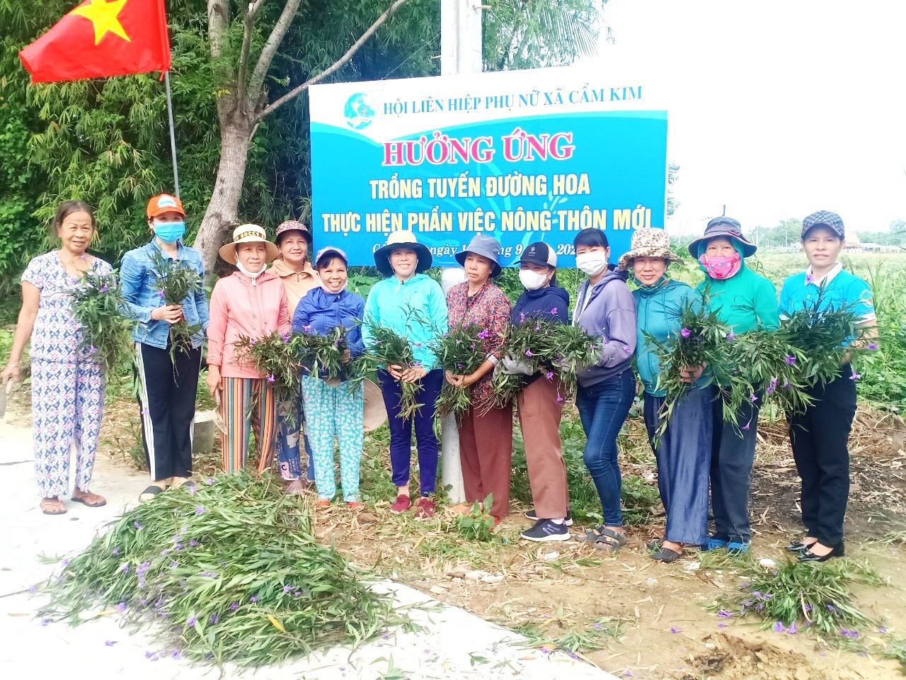 Cán bộ, hội viên phụ nữ xã Cẩm Kim ra quân trồng đường hoa góp phần xây dựng cảnh quan nông thôn mới.