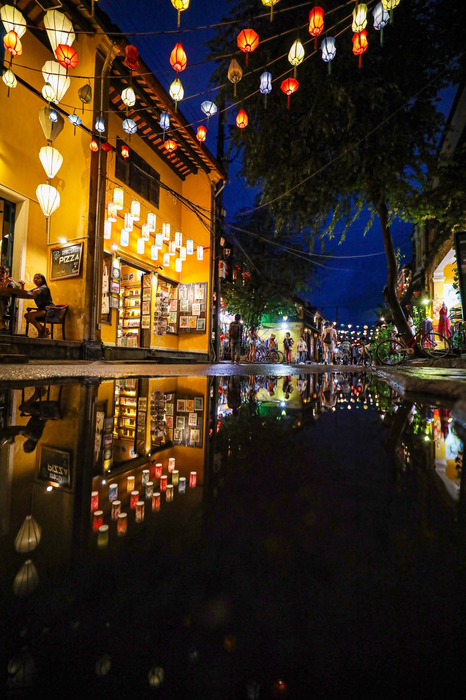 Hoi An ancient town reflected in rainwater puddles