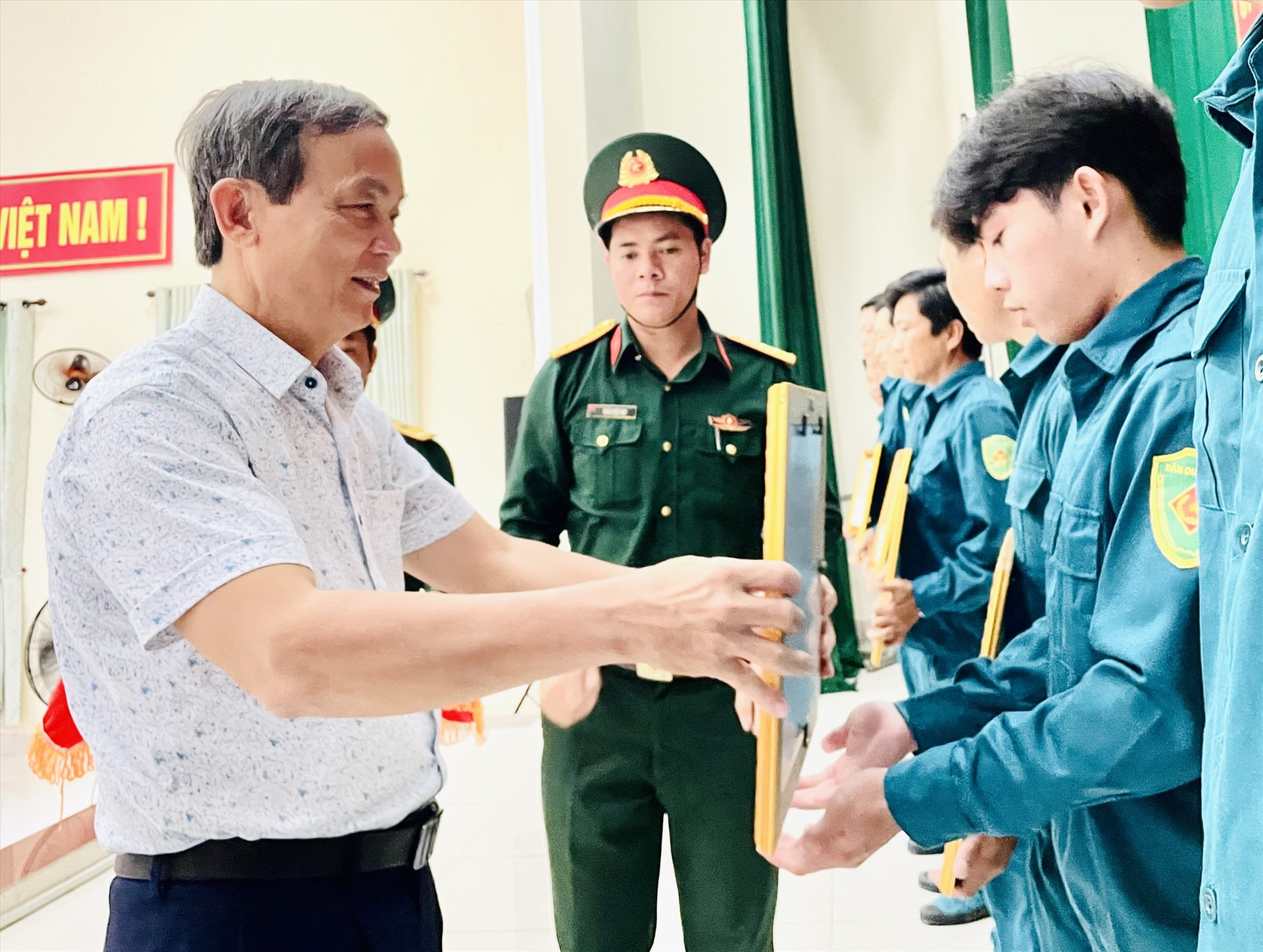 Ông Phan Xuân Cảnh – Chủ tịch UBND huyện Duy Xuyên trao giấy khen cho các tập thể, cá nhân có thành tích tốt trong thực hiện nhiệm vụ quốc phòng, quân sự địa phương năm 2023. Ảnh: MINH TÂM