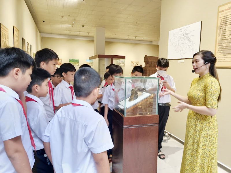 Hướng dẫn viên cho học sinh tham quan, học tập ở Bảo tàng Quảng Nam. Ảnh: C.N