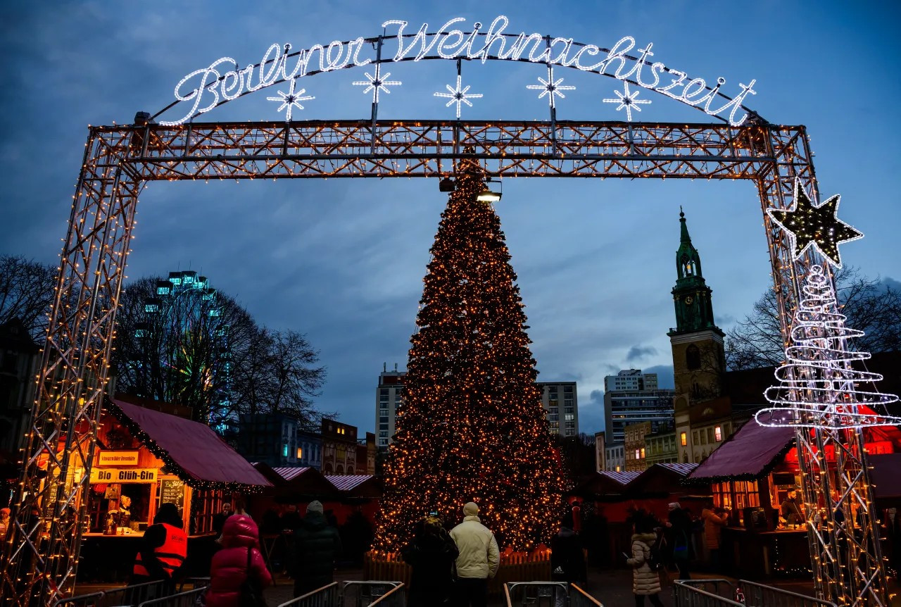 A Christmas tree greets visitors at the entrance to a traditional Christmas market in Berlin on Dec. 22, 2023, as the Marienkirche church, right, is seen in the background. (JOHN MACDOUGALL/AFP via Getty Images)