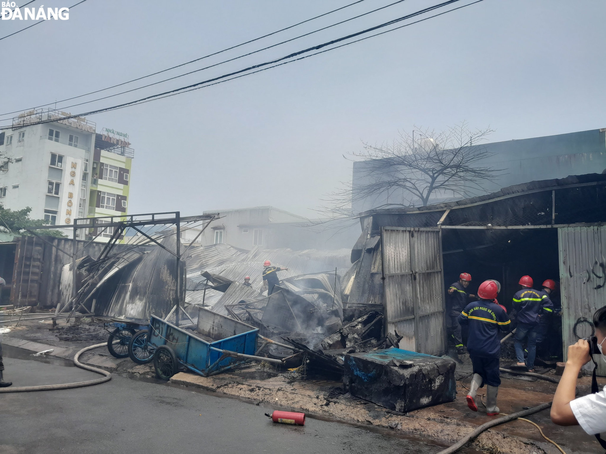 Lực lượng cảnh sát phòng cháy, chữa cháy và cứu nạn, cứu hộ tiếp cận vào bên trong khu vực kho chứa vật dụng để dập tắt lửa. Ảnh: LÊ HÙNG