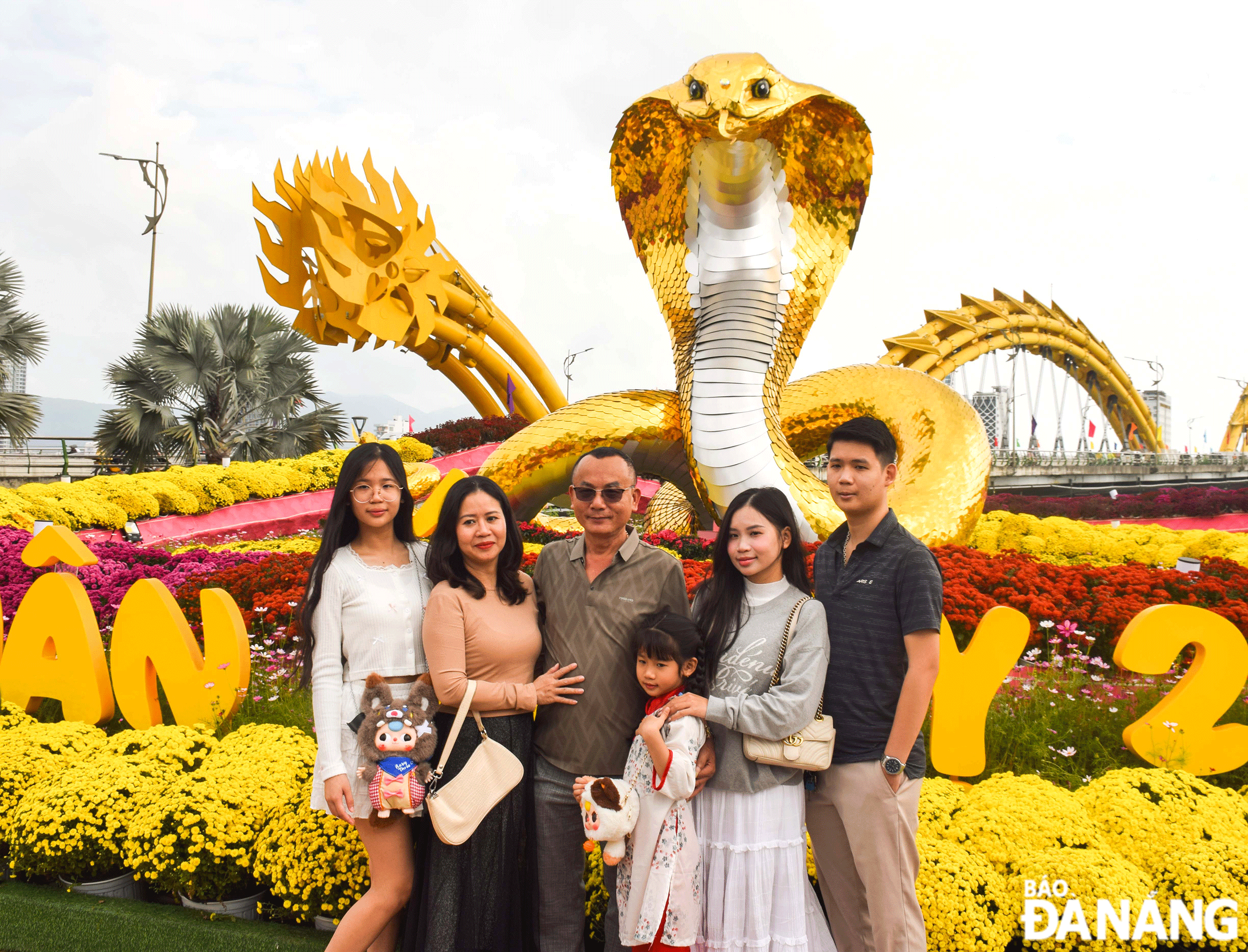 Du khách hứng khởi check-in tại đường hoa Bạch Đằng. Ảnh: ĐOÀN HẠO LƯƠNG