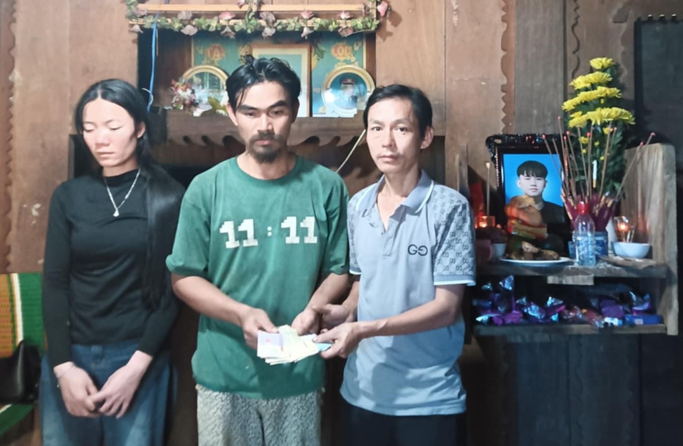 Anh Chánh (bên trái) đến thăm, trao số tiền huy động được 29 triệu đồng cho một gia đình khó khăn, có con bị tai nạn đột xuất qua đời ngày 9.4.2025 tại xã Trà Giác. Ảnh: BÌNH MINH.
