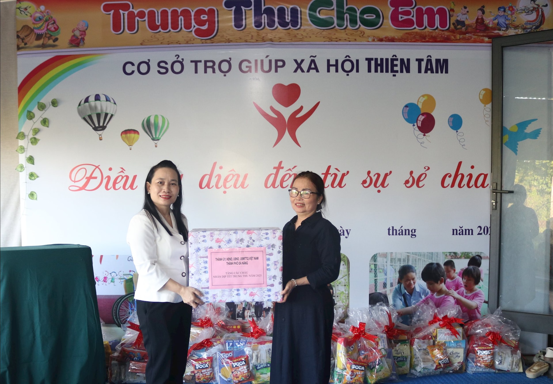 Enhetsrepresentanten, chef för Thien Tam socialhjälpsanläggning Le Thi Ly, tog emot en gåva från biträdande chef för stadens hälsovårdsavdelning Doan Thi Hoai Nhi. Foto: HOANG LIEN