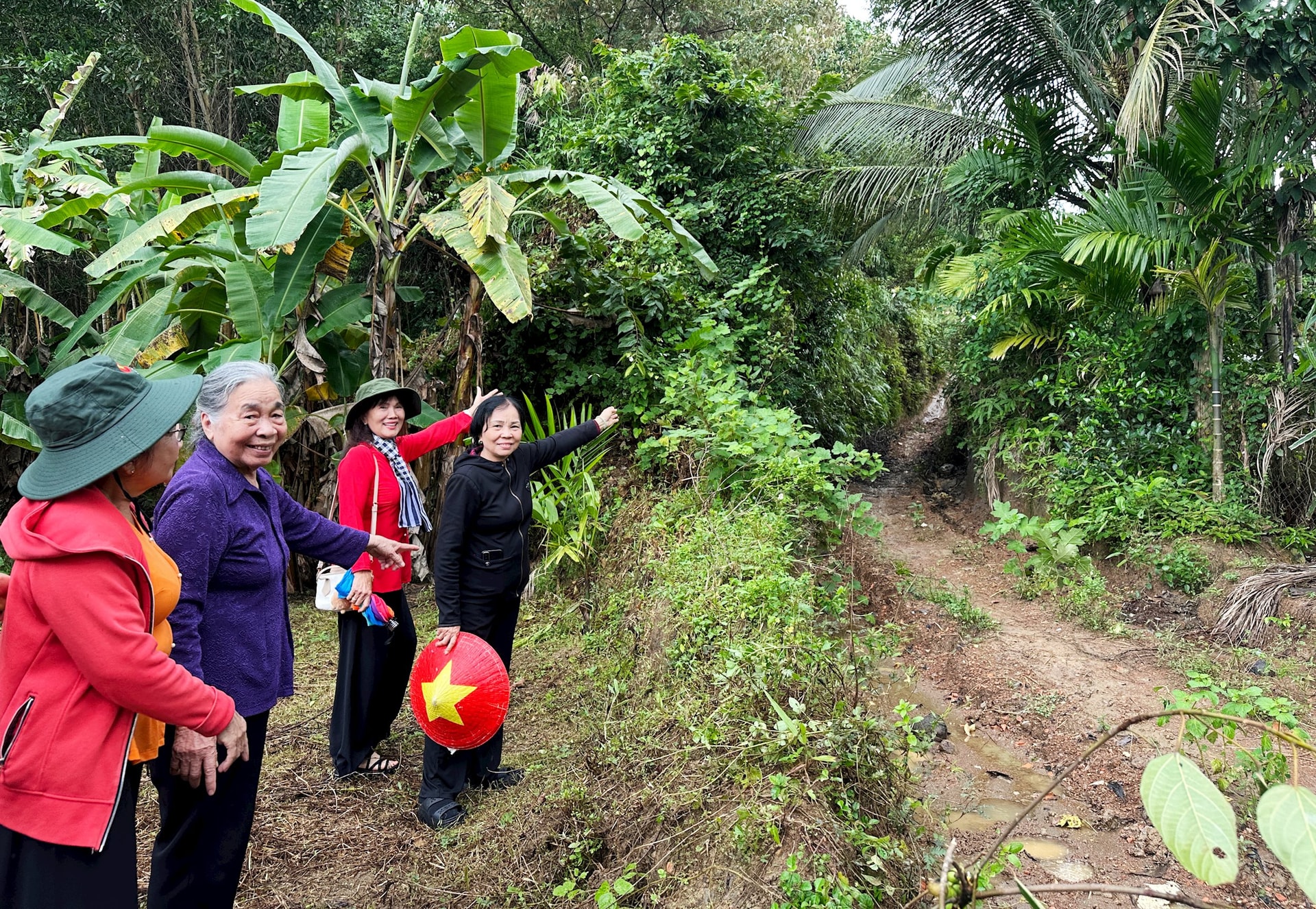 Anh hùng Lực lượng Vũ trang nhân dân Hồ Thị Kim Thanh (áo tím) thăm địa điểm Hóc Sen