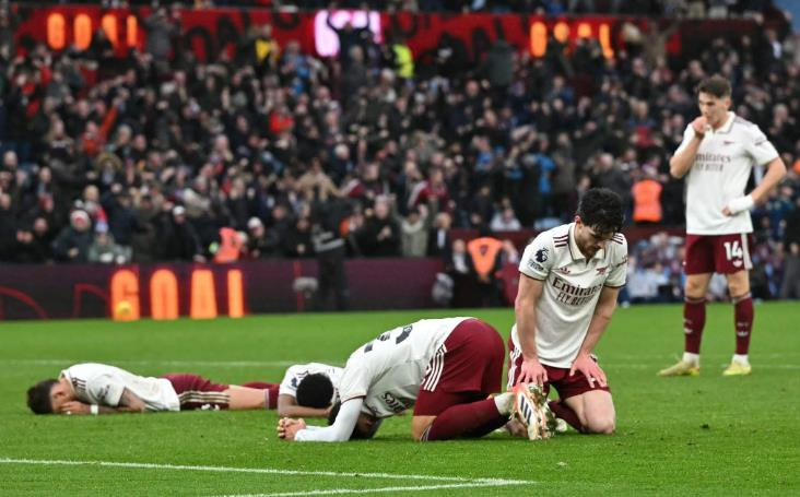 Các cầu thủ Arsenal đổ gục xuống sân sau bàn thắng quyết định của Emiliano Buendia.
