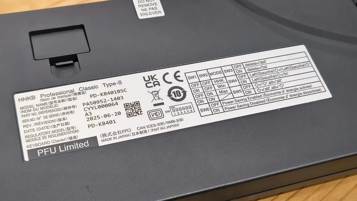 Bàn phím HHKB với cáp USB-C kết nối, đặt cạnh một thiết bị khác.