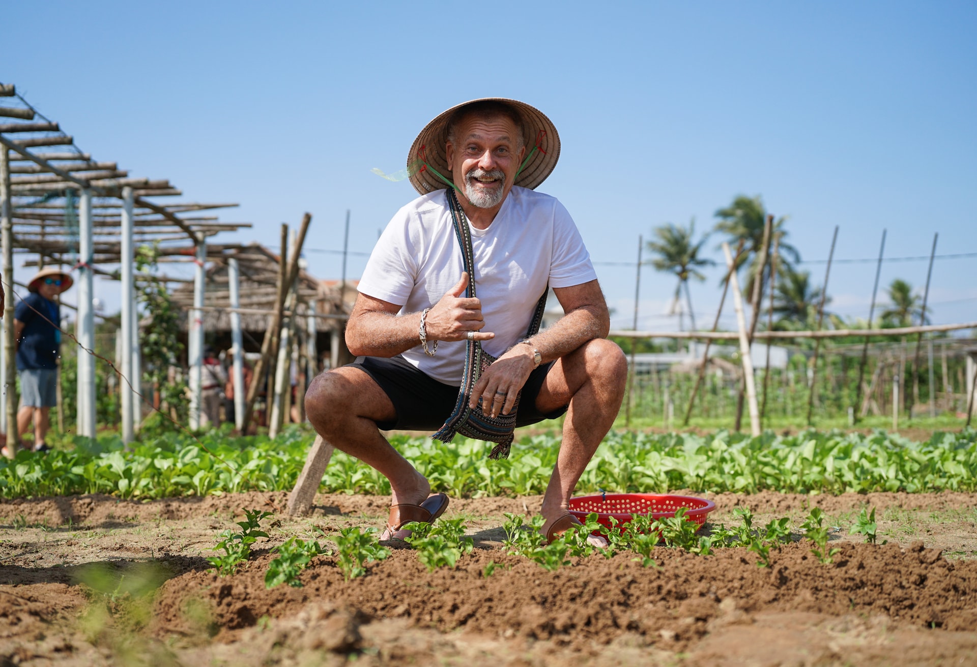 Ông Miki Migurl, du khách từ Mỹ bên những vạt rau do mình gieo trồng tại vườn rau Thanh Đông. Ảnh: XUÂN SƠN