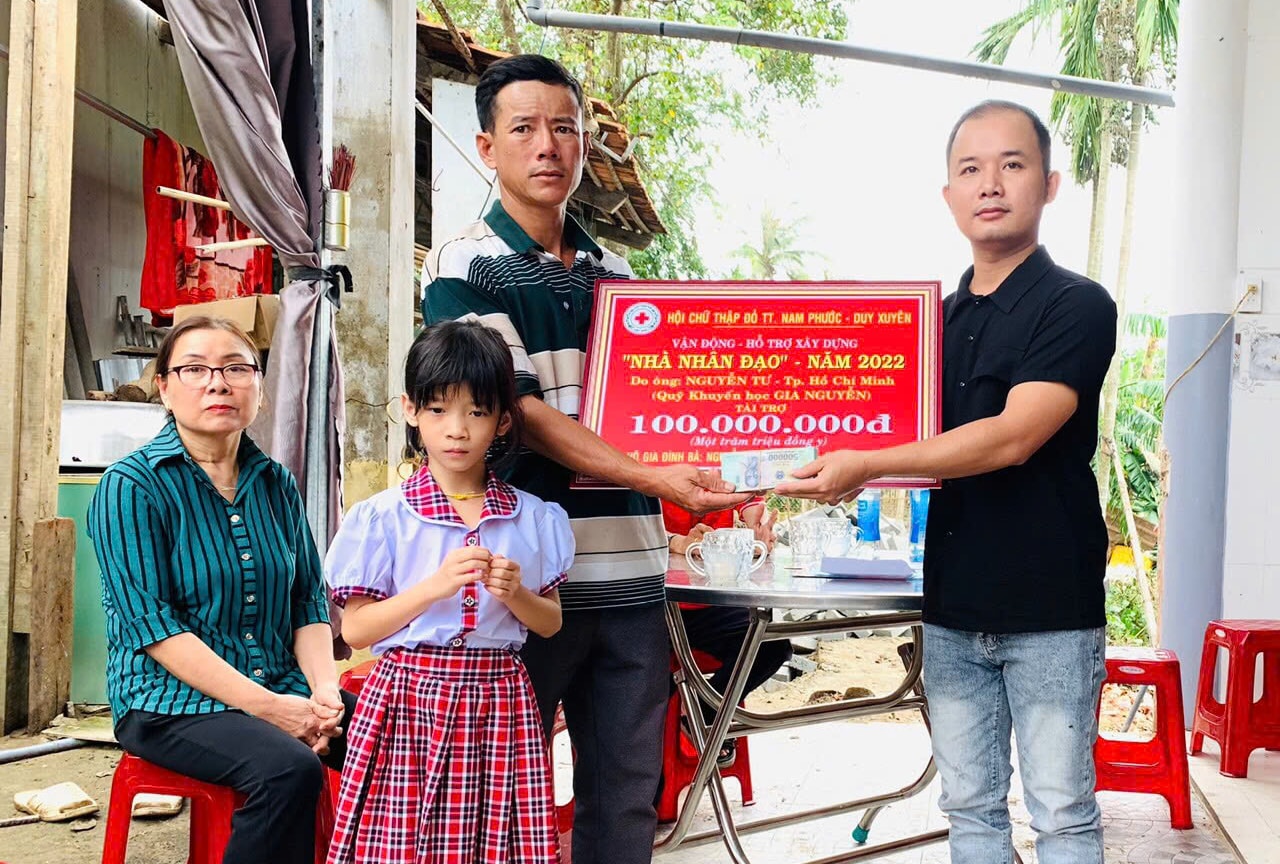 Đại diện gia đình ông Nguyễn tư trao 100 triệu đồng hỗ trợ xây nhà cho bà con ở quê nhà Nam Phước
