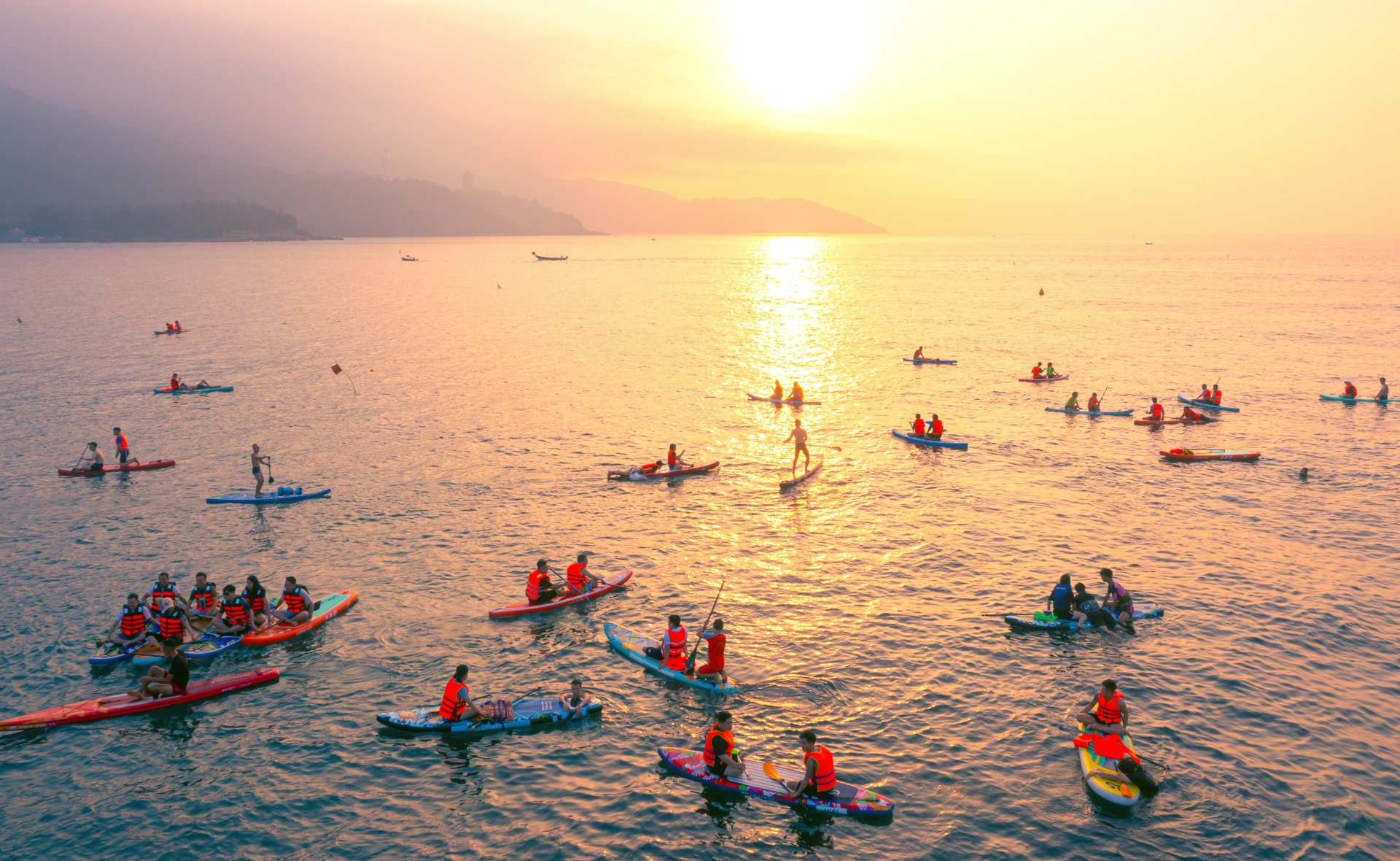 Stand-up paddleboarding at sunrise has become a favorite experience for many visitors exploring Da Nang during the summer season.