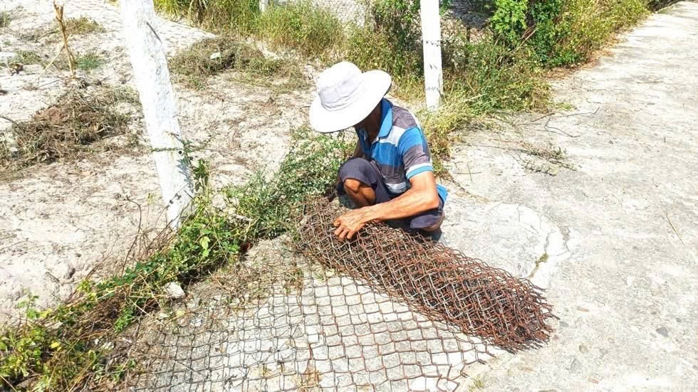 Người dân thôn Ngọc Sơn Tây, xã Thăng Bình, tháo dỡ hàng rào, cổng ngõ để tạo mặt bằng cho đơn vị thi công. Ảnh: HẢI HƯNG