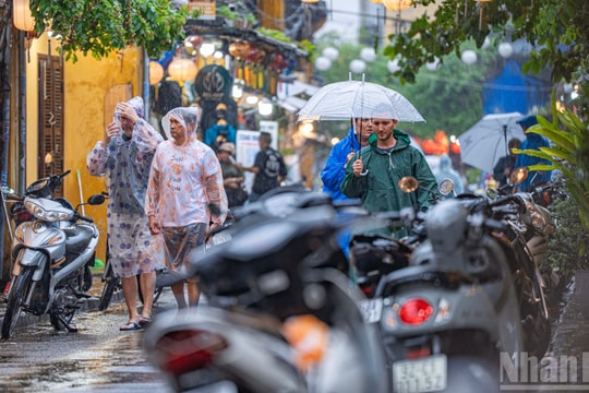 Tourists enjoy wading through floodwaters in Hoi An